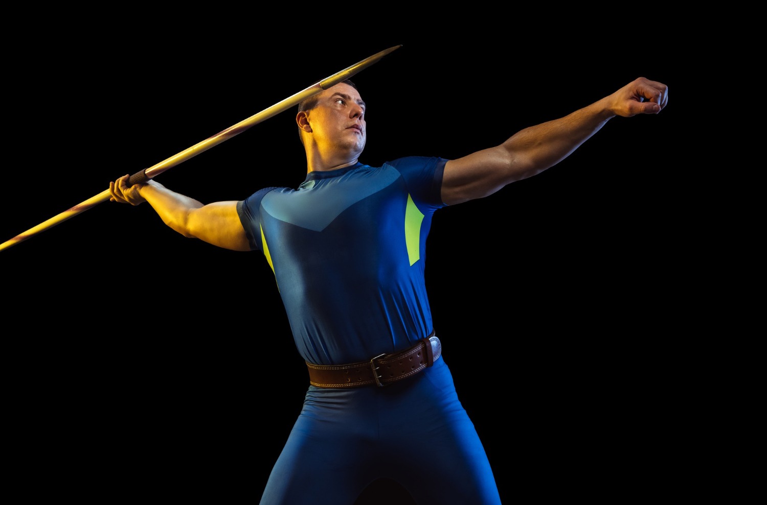 male-athlete-practicing-throwing-javelin-isolated-black-studio-neon-light