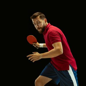 young-man-playing-table-tennis-black